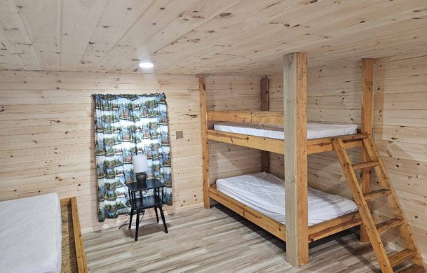 Rustic Cabin interior with bunk bed and regular bed